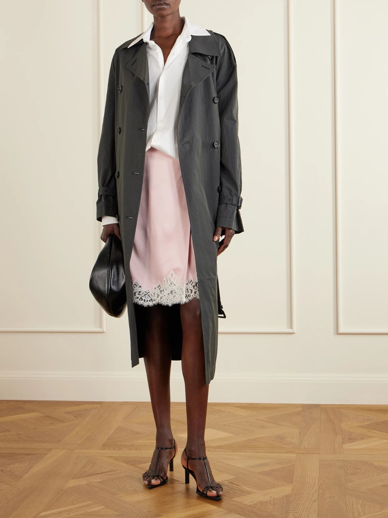 Image of a model wearing Skirts. Product name - Lace-trimmed Satin Midi Skirt in Pink colour by brand - Stella McCartney