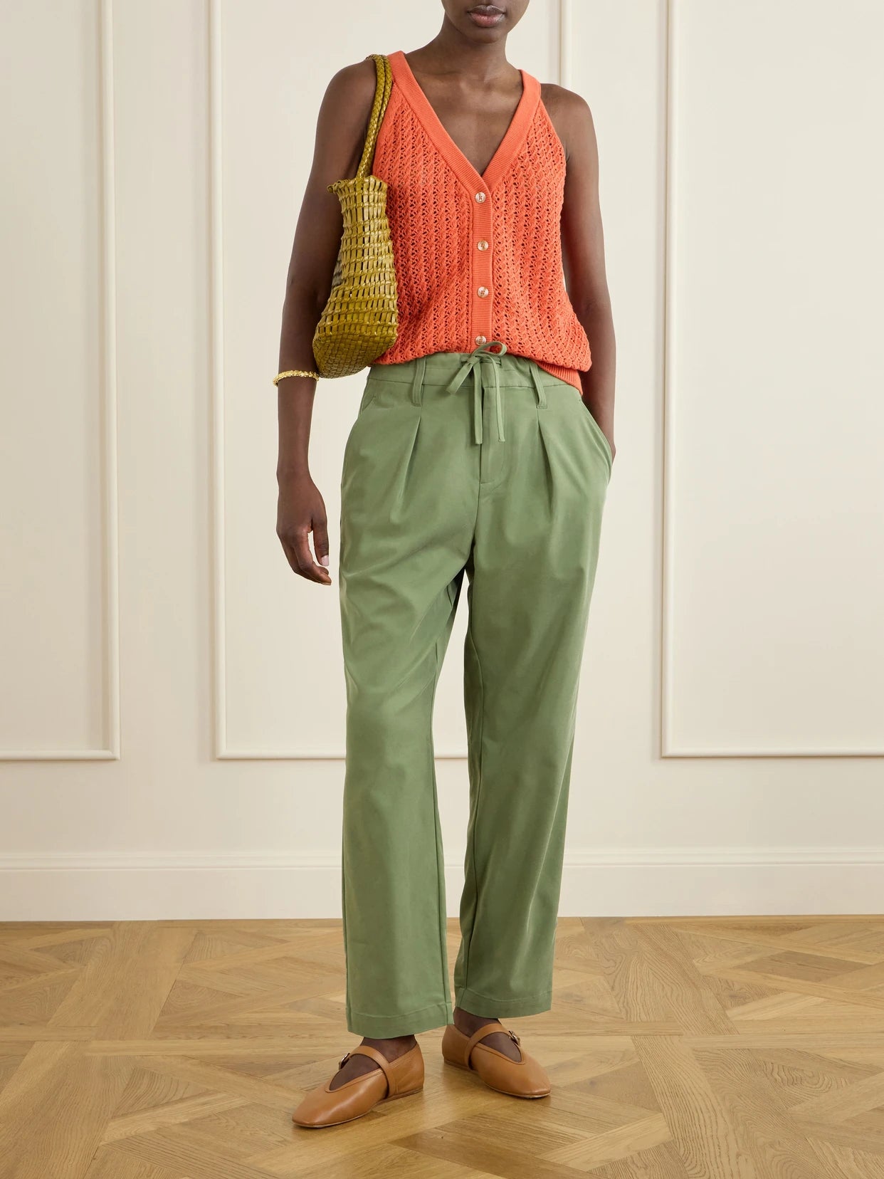 Image of a model wearing Tops. Product name - Alessia Crochet-knit Cotton Top in Orange colour by brand - Varley
