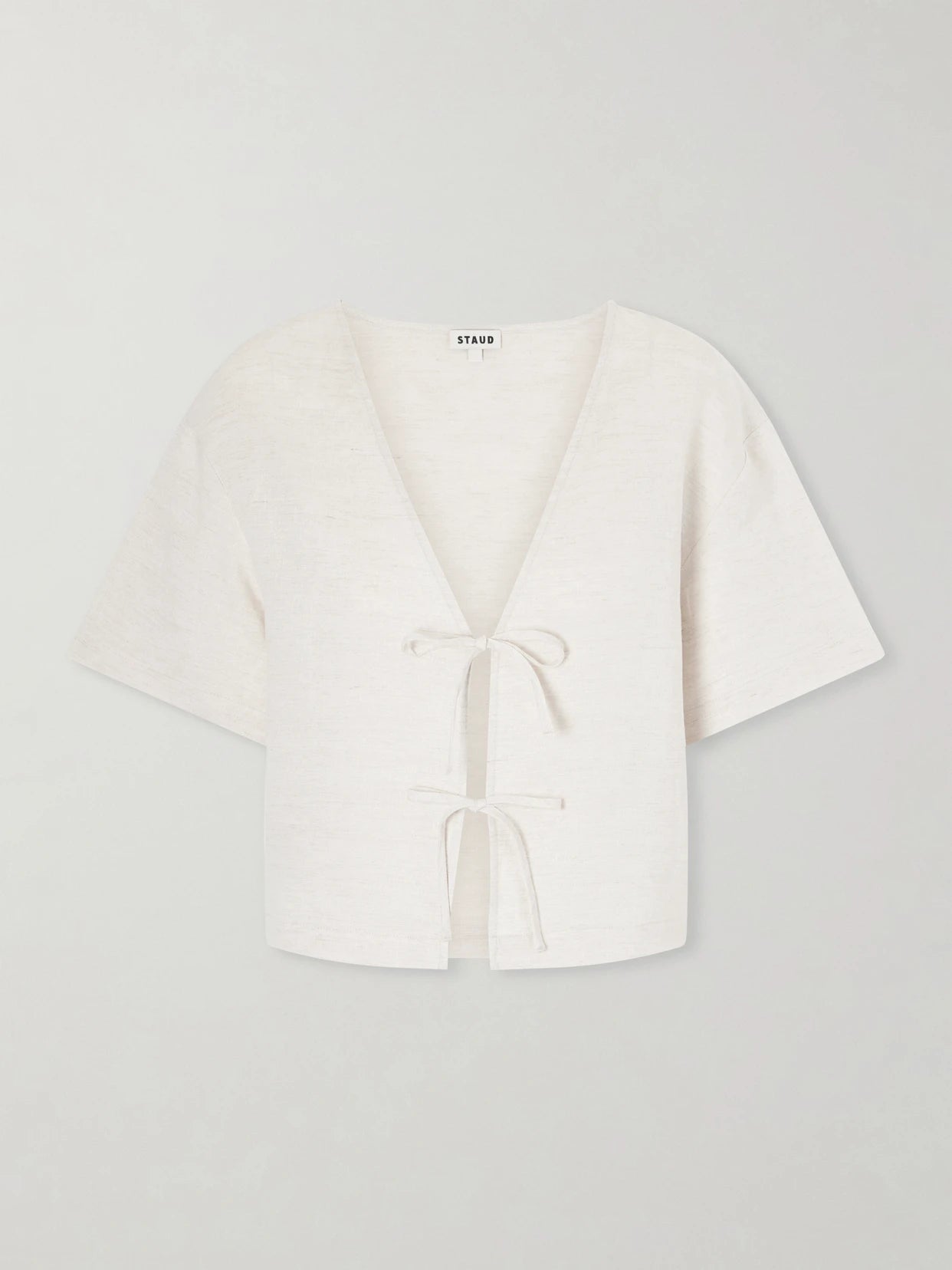 Image of a model wearing Tops. Product name - Ava Linen Blouse in Off-white colour by brand - STAUD