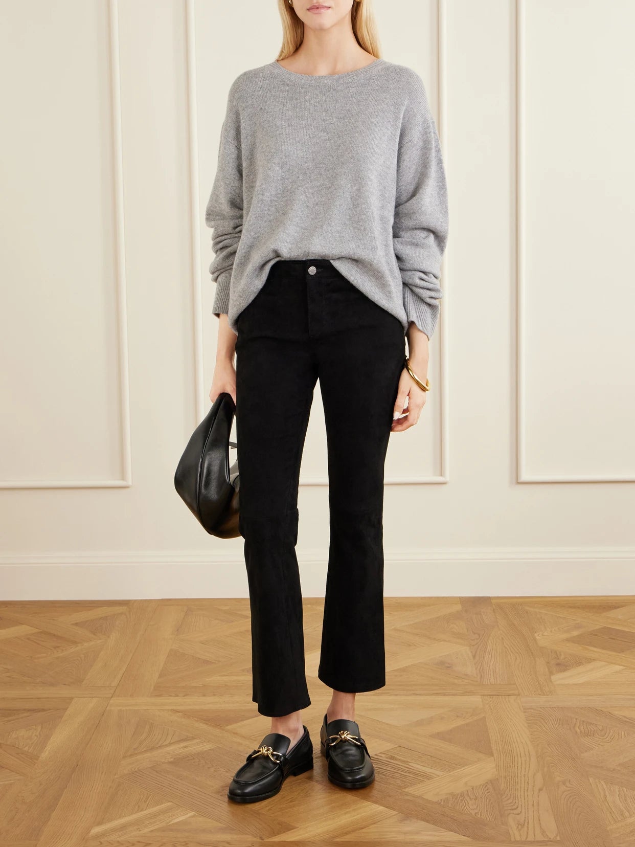 Image of a model wearing Pants. Product name - Dean Suede Flared Pants in Black colour by brand - STOULS