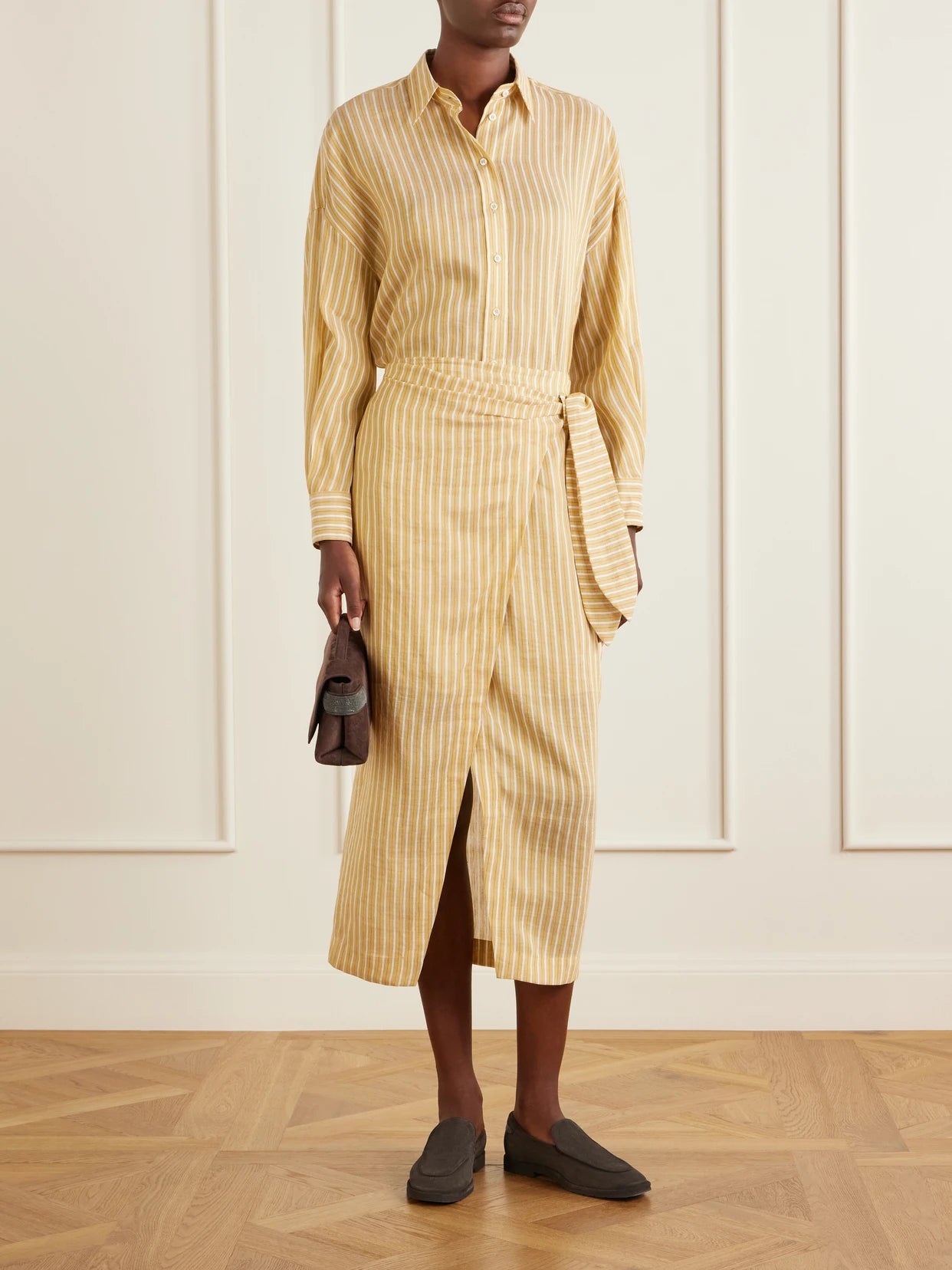 Image of a model wearing Skirts. Product name - Linen And Silk-blend Midi Skirt in Mustard colour by brand - Brunello Cucinelli
