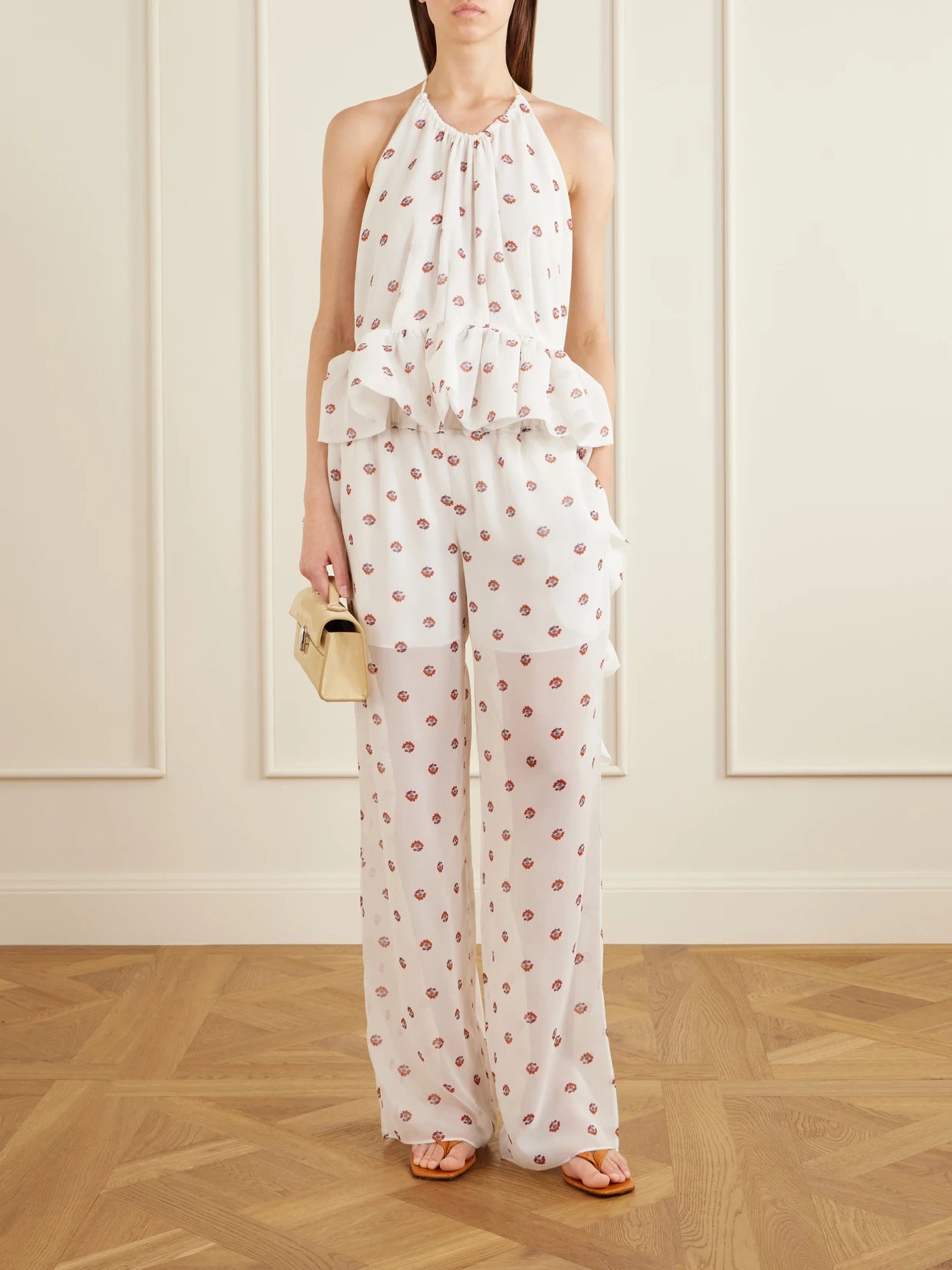 Image of a model wearing Pants. Product name - Palazzo Floral-print Wide-leg Silk Pants in White colour by brand - LIBEROWE