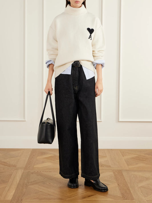 Image of a model wearing Outerwear. Product name - Oversized Logo-intarsia Wool Turtleneck Sweater in Cream, Dark gray colour by brand - AMI PARIS