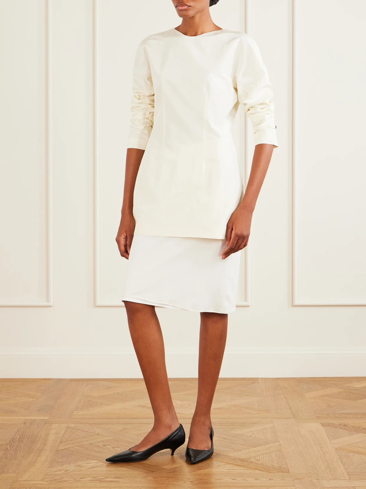 Image of a model wearing Tops. Product name - Elione Cotton And Silk Blouse in White colour by brand - The Row