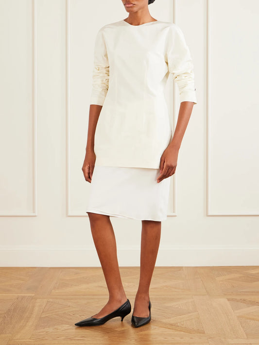 Image of a model wearing Tops. Product name - Elione Cotton And Silk Blouse in White colour by brand - The Row