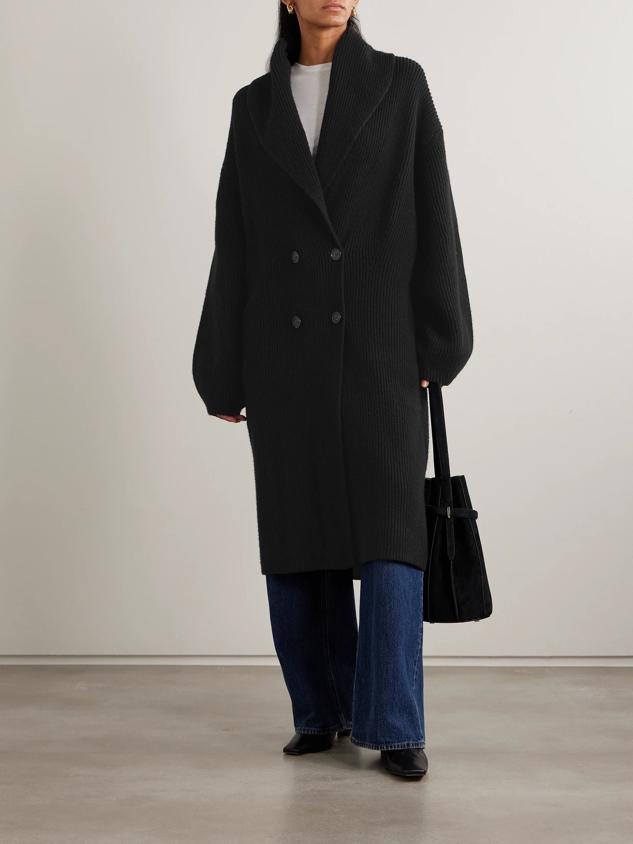 Image of a model wearing Outerwear. Product name - Double-breasted Ribbed Wool Cardigan in Black colour by brand - TOTEME
