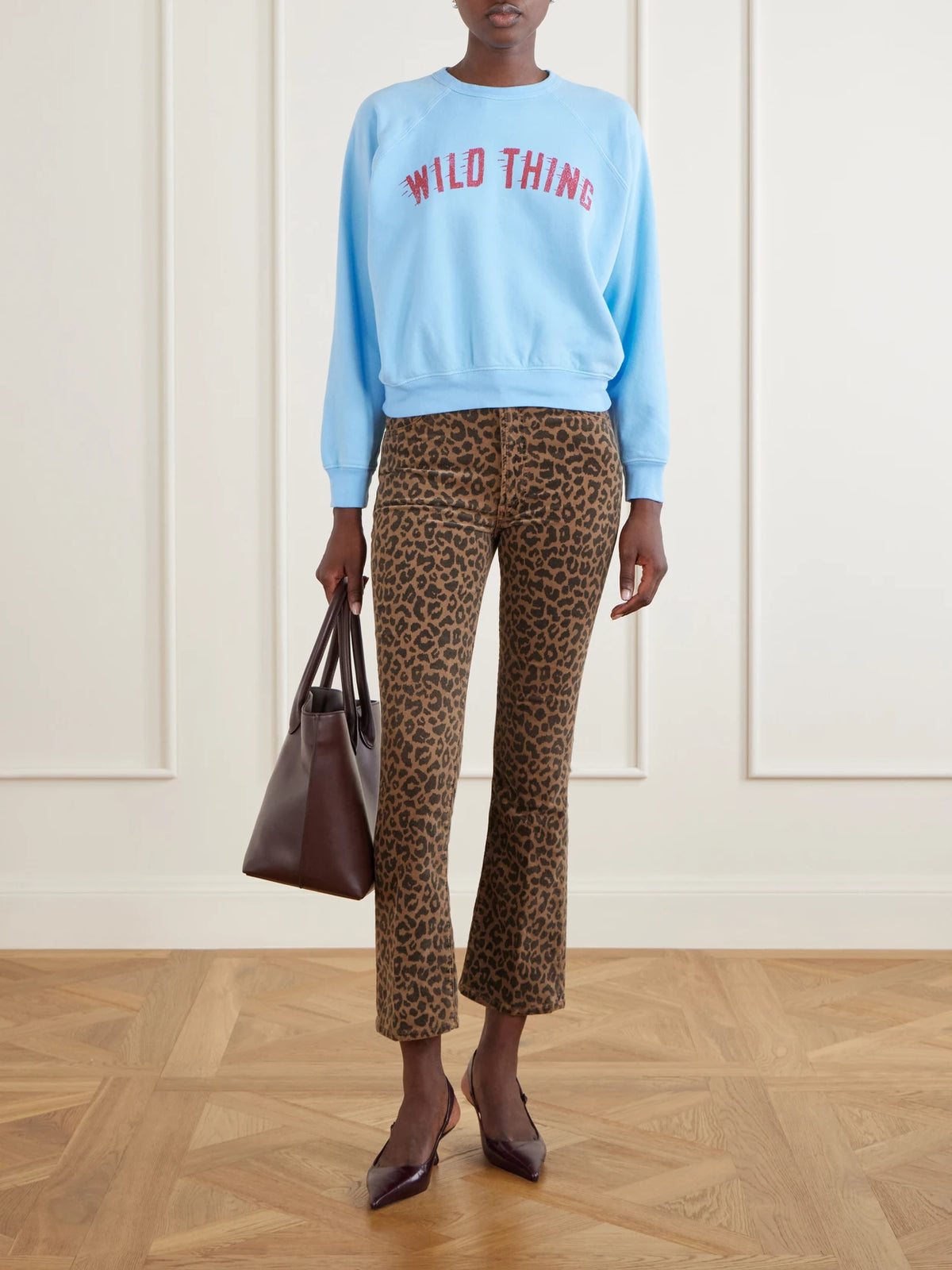 Image of a model wearing Pants. Product name - The Hustler Flood Leopard-print Cotton-blend Corduroy High-rise Flared Pants in Leopard print colour by brand - Mother