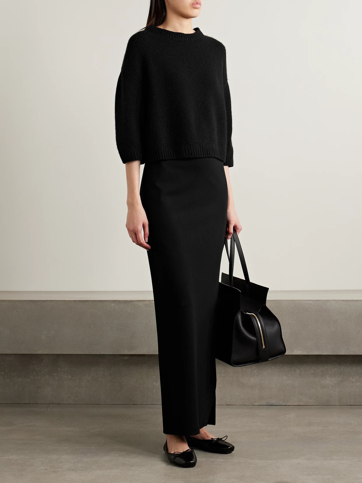 Image of a model wearing Outerwear. Product name - Sabina Cashmere Sweater in Black colour by brand - KHAITE