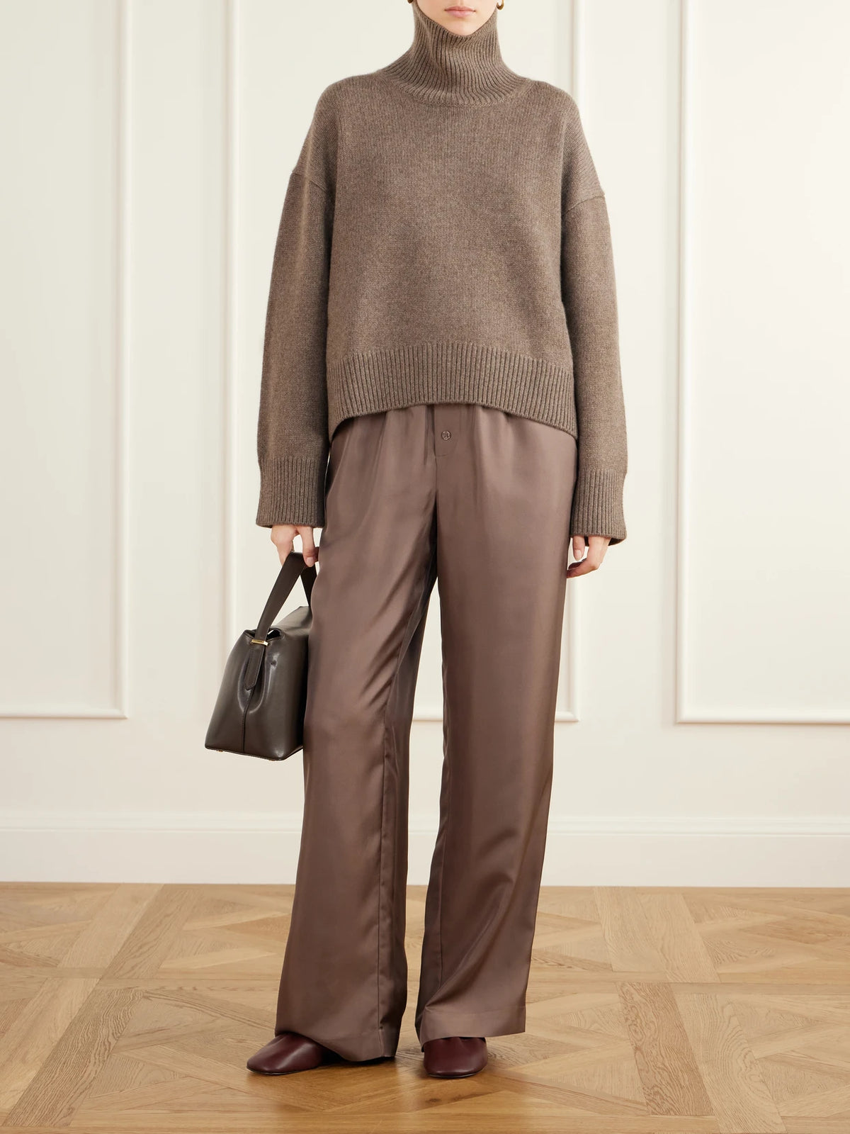 Image of a model wearing Outerwear. Product name - Jonah Cropped Cashmere Turtleneck Sweater in Brown colour by brand - Loulou de Saison