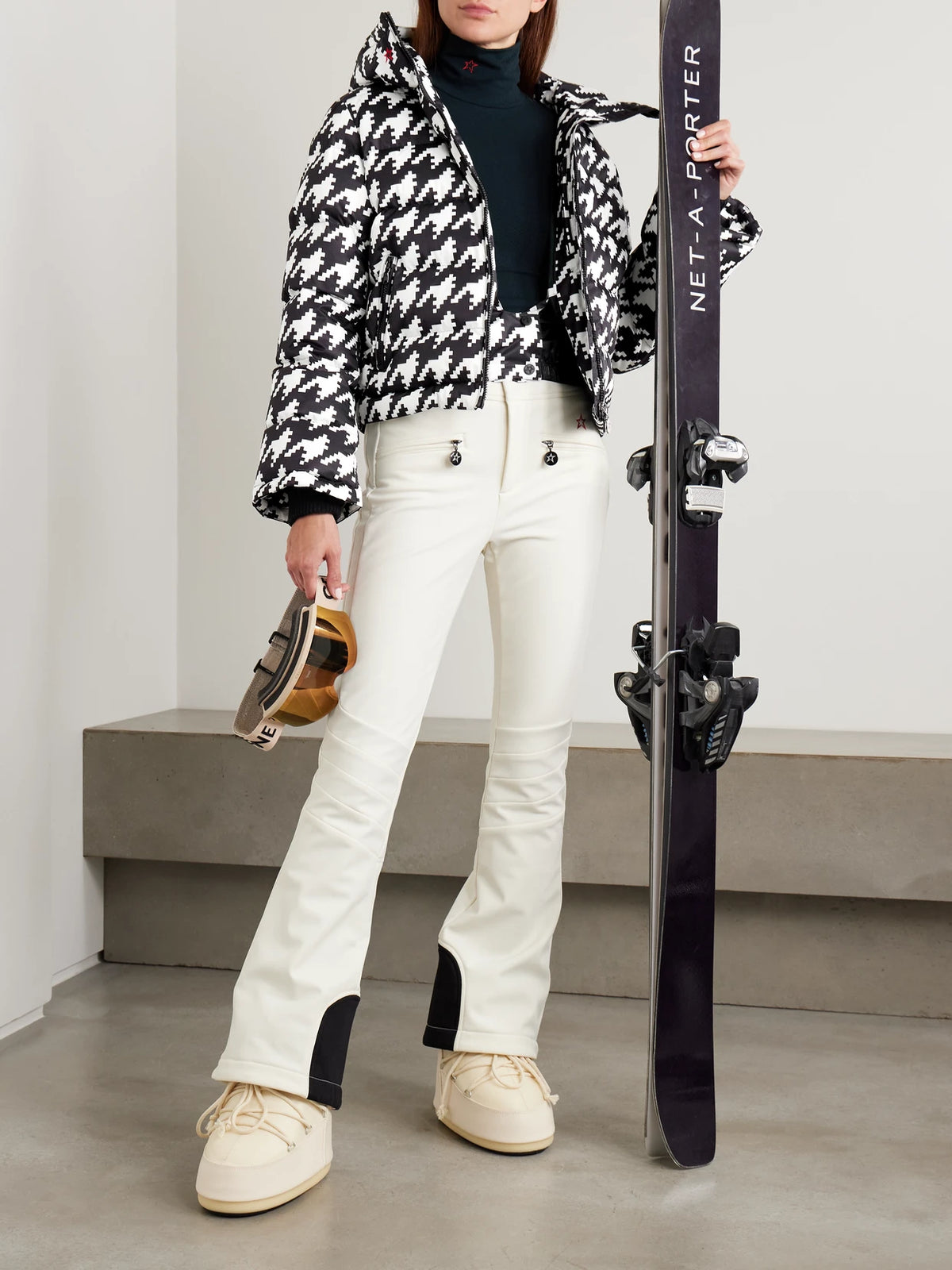 Image of a model wearing Pants. Product name - Aurora Embroidered Bootcut Ski Pants in White colour by brand - Perfect Moment