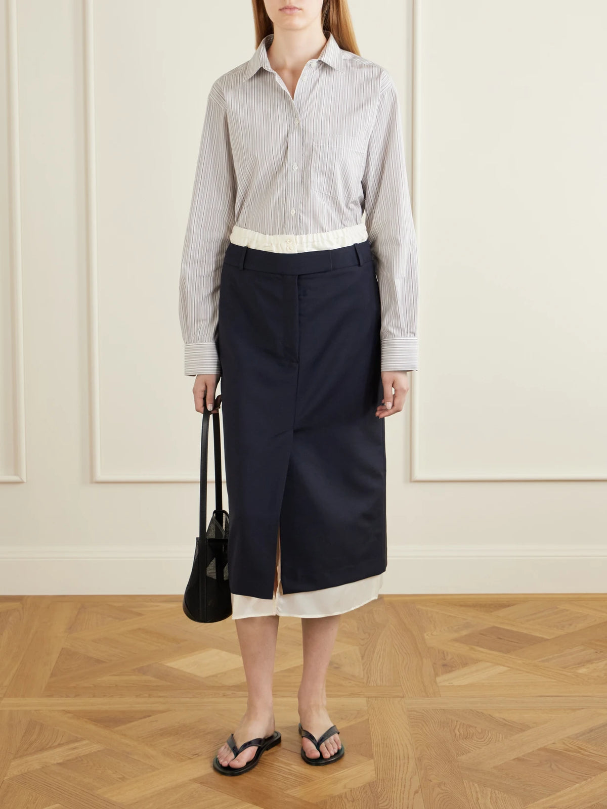 Image of a model wearing Skirts. Product name - Ruched Wool And Mohair-blend Midi Skirt in Navy colour by brand - RÓHE