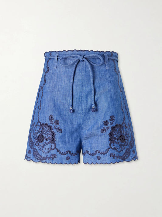 Image of a model wearing Shorts. Product name - Aster Scalloped Embroidered Denim Shorts in Blue colour by brand - Zimmermann