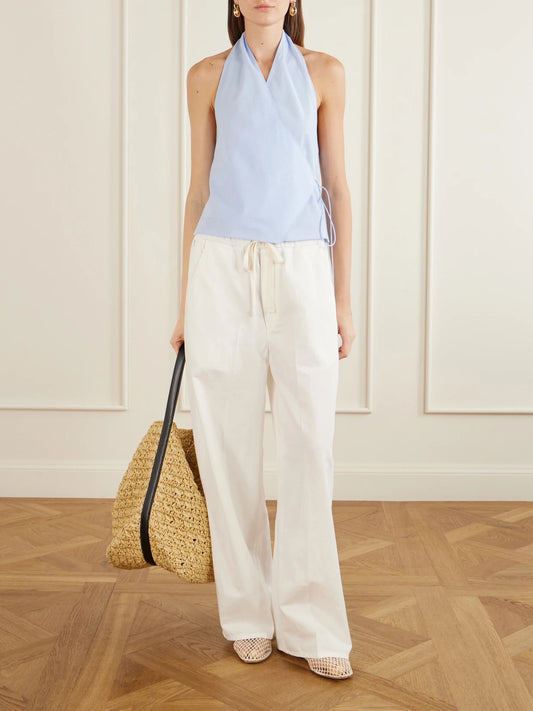 Image of a model wearing Tops. Product name - Organic Cotton-poplin Wrap Top in Light blue colour by brand - ST. AGNI