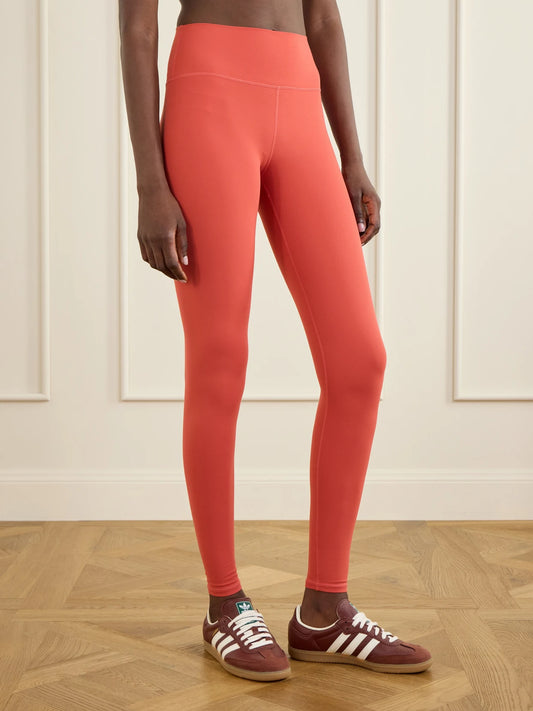 Image of a model wearing Pants. Product name - Always High Rise Stretch Recycled Leggings in Red colour by brand - Varley