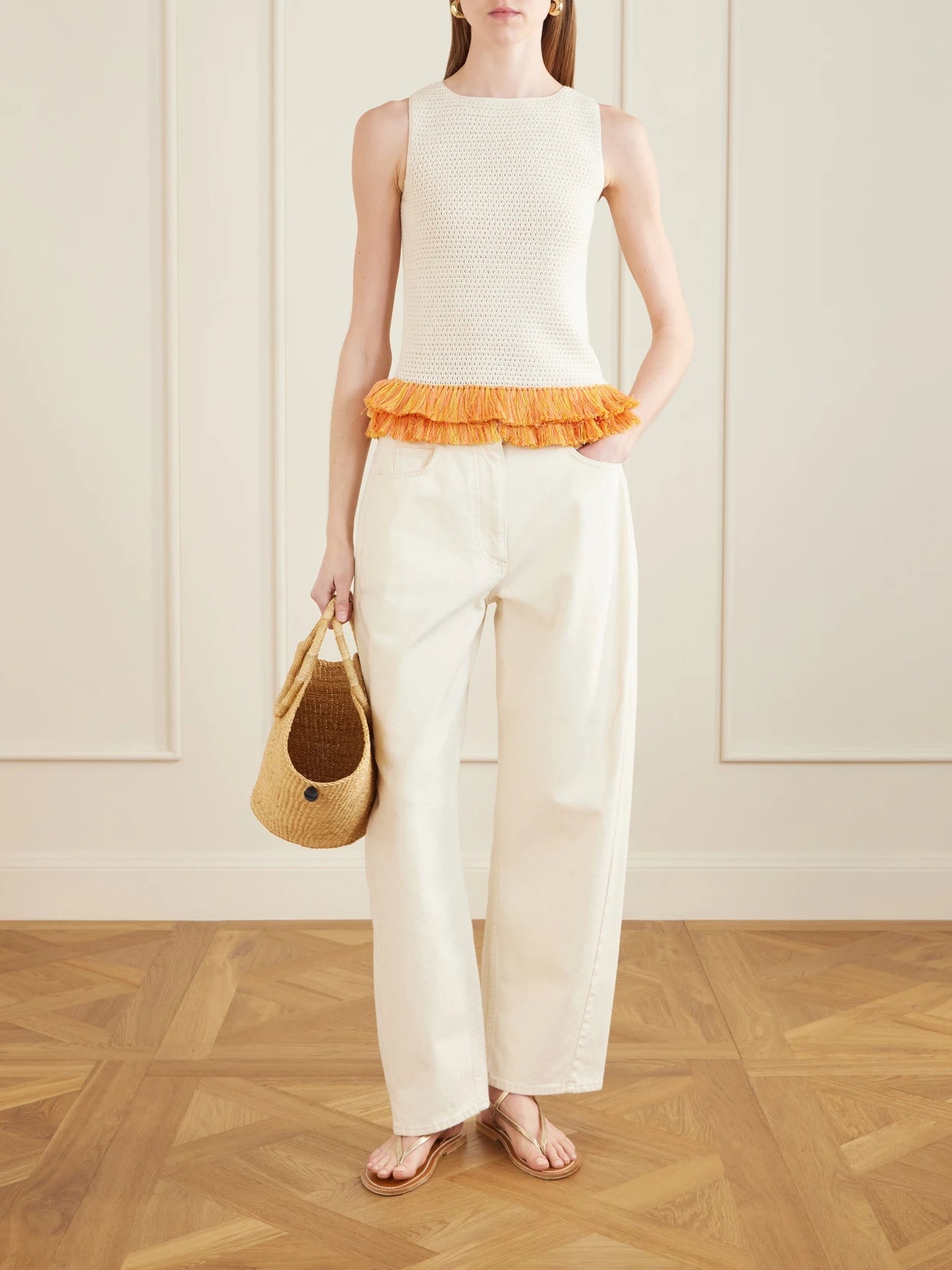 Image of a model wearing Tops. Product name - Amada Fringed Crocheted Cotton Tank in Ivory colour by brand - ESCVDO