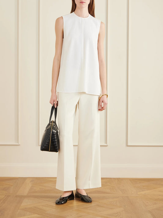 Image of a model wearing Tops. Product name - Woven Tank in Off-white colour by brand - TOTEME