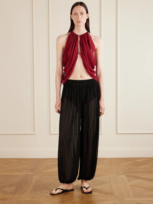 Image of a model wearing Tops. Product name - Reysa Ruched Silk-crepe Top in Burgundy colour by brand - AFLALO