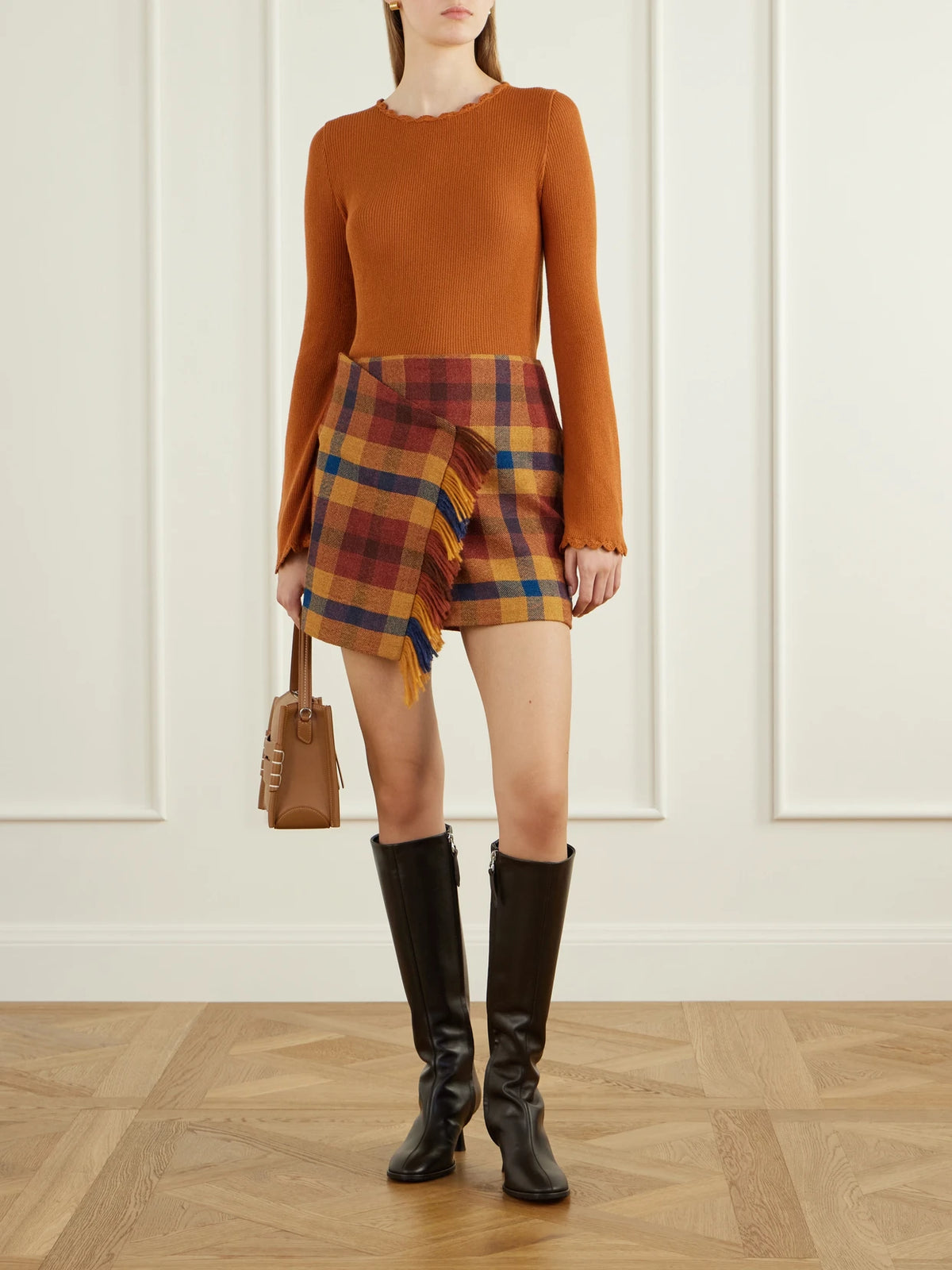 Image of a model wearing Skirts. Product name - Checked Asymmetric Alpaca Mini Skirt in Multi colour by brand - ESCVDO