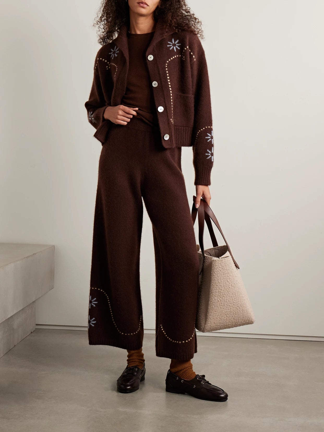 Image of a model wearing Outerwear. Product name - Intarsia-knit Cashmere Wide-leg Pants in Chocolate colour by brand - Calle Del Mar