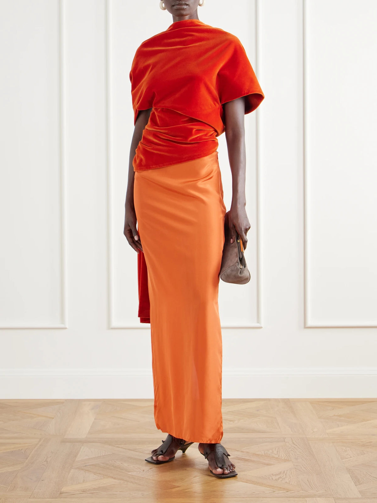 Image of a model wearing Tops. Product name - Draped Cotton-velvet Top in Orange colour by brand - Colleen Allen