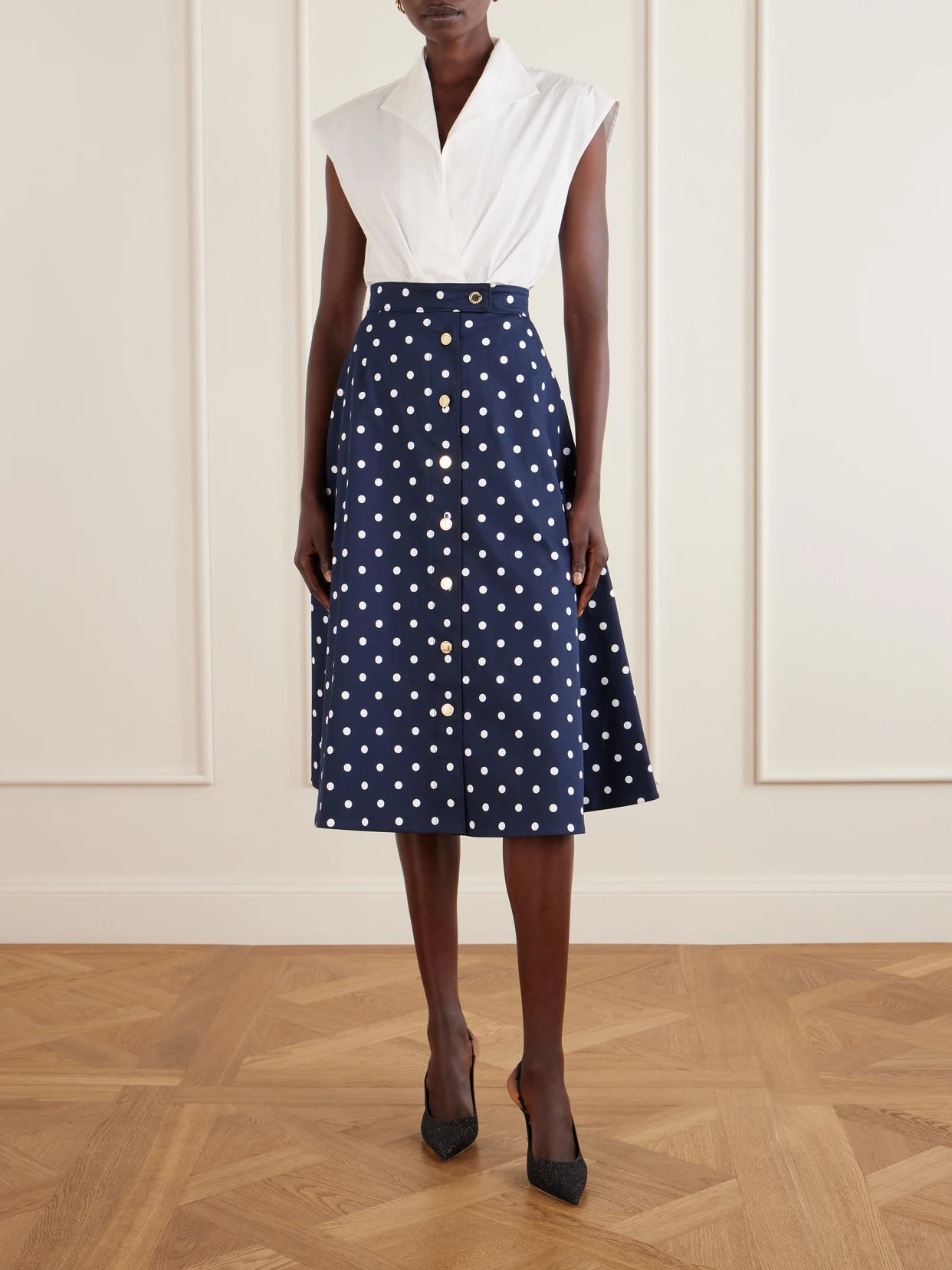 Image of a model wearing Skirts. Product name - Polka-dot Cotton-blend Twill Midi Skirt in Navy colour by brand - Carolina Herrera