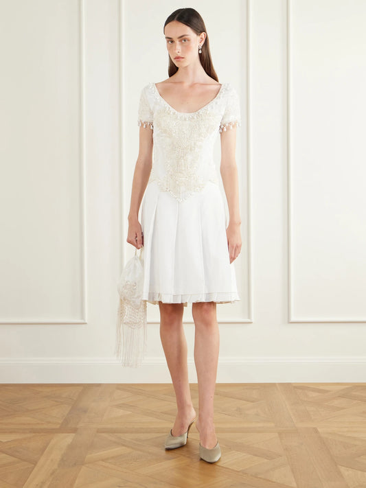 Image of a model wearing Tops. Product name - Bead-embellished Velvet Corset Top in Cream colour by brand - Anna Sui
