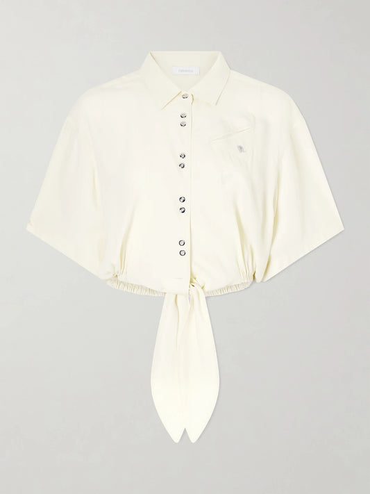 Image of a model wearing Tops. Product name - Logo-embellished Knotted Blouse in Yellow colour by brand - RABANNE