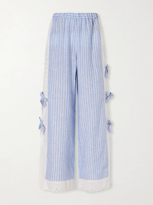 Image of a model wearing Pants. Product name - Clarissa Bow-embellished Striped Broderie Anglaise-trimmed Linen Straight-leg Pants in Blue colour by brand - Loretta Caponi