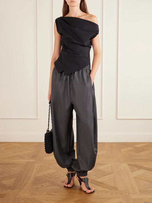 Image of a model wearing Tops. Product name - Off-the-shoulder Draped Jersey Blouse in Black colour by brand - RÓHE