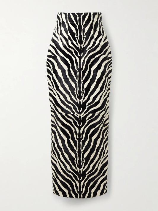 Image of a model wearing Skirts. Product name - Loxley Zebra-print Calf Hair Midi Skirt in Zebra print colour by brand - KHAITE