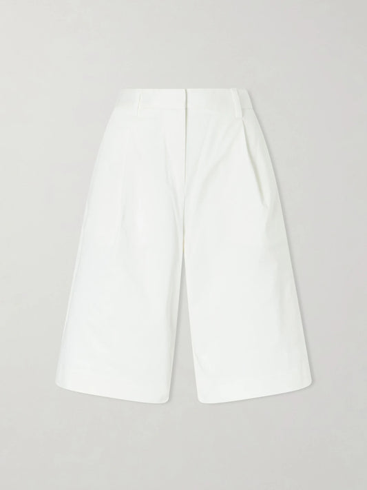 Image of a model wearing Shorts. Product name - Pleated Organic Cotton-blend Twill Shorts in White colour by brand - Matteau