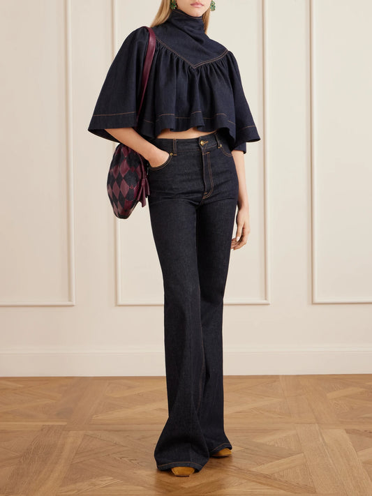 Image of a model wearing Tops. Product name - Cape-effect Denim Top in Blue colour by brand - Zimmermann