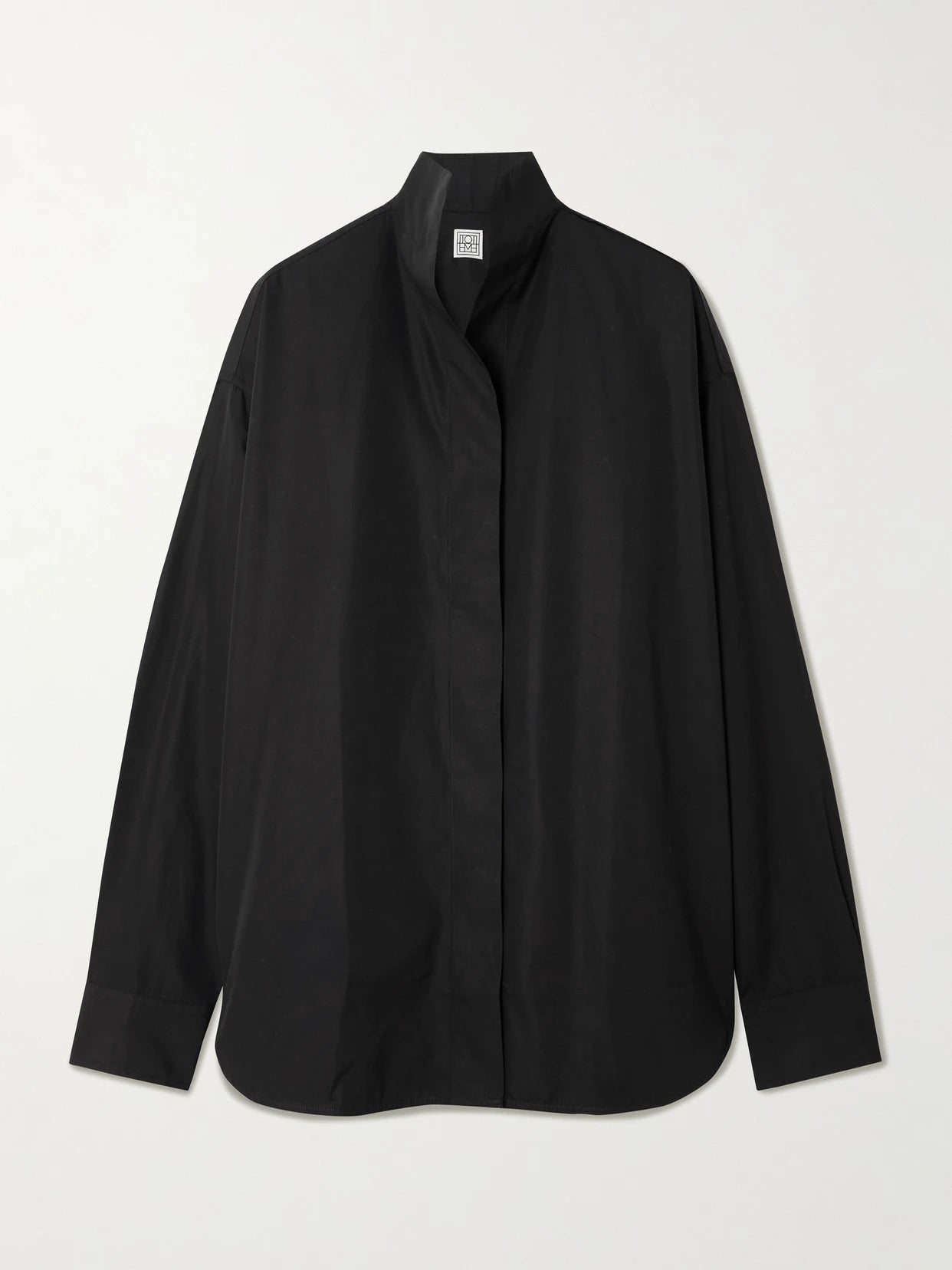 Image of a model wearing Tops. Product name - Sharp Oversized Cotton-poplin Shirt in Black colour by brand - TOTEME