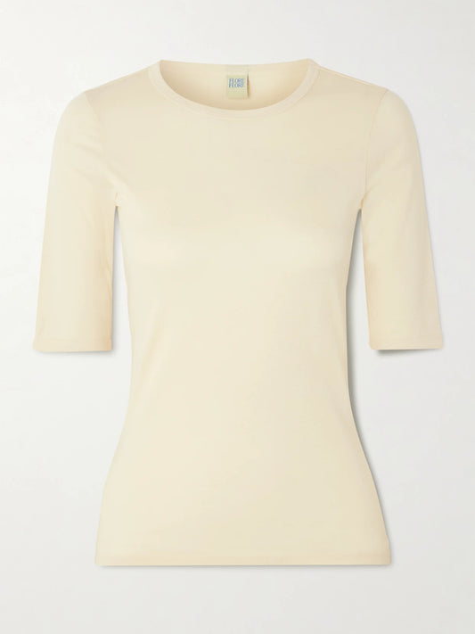Image of a model wearing Tops. Product name - Anna Organic Cotton-jersey T-shirt in Ecru colour by brand - FLORE FLORE
