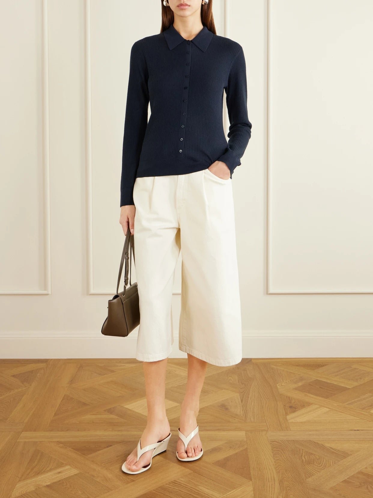 Image of a model wearing Outerwear. Product name - Agata Ribbed Cashmere Cardigan in Navy colour by brand - LISA YANG