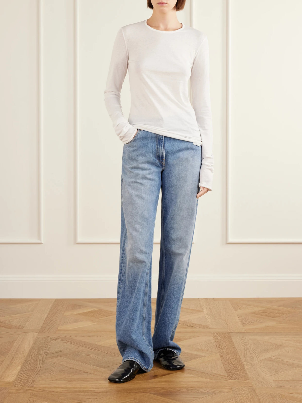 Image of a model wearing Tops. Product name - Gardénia Cotton-jersey T-shirt in Off-white, Black colour by brand - Calvin Klein Collection