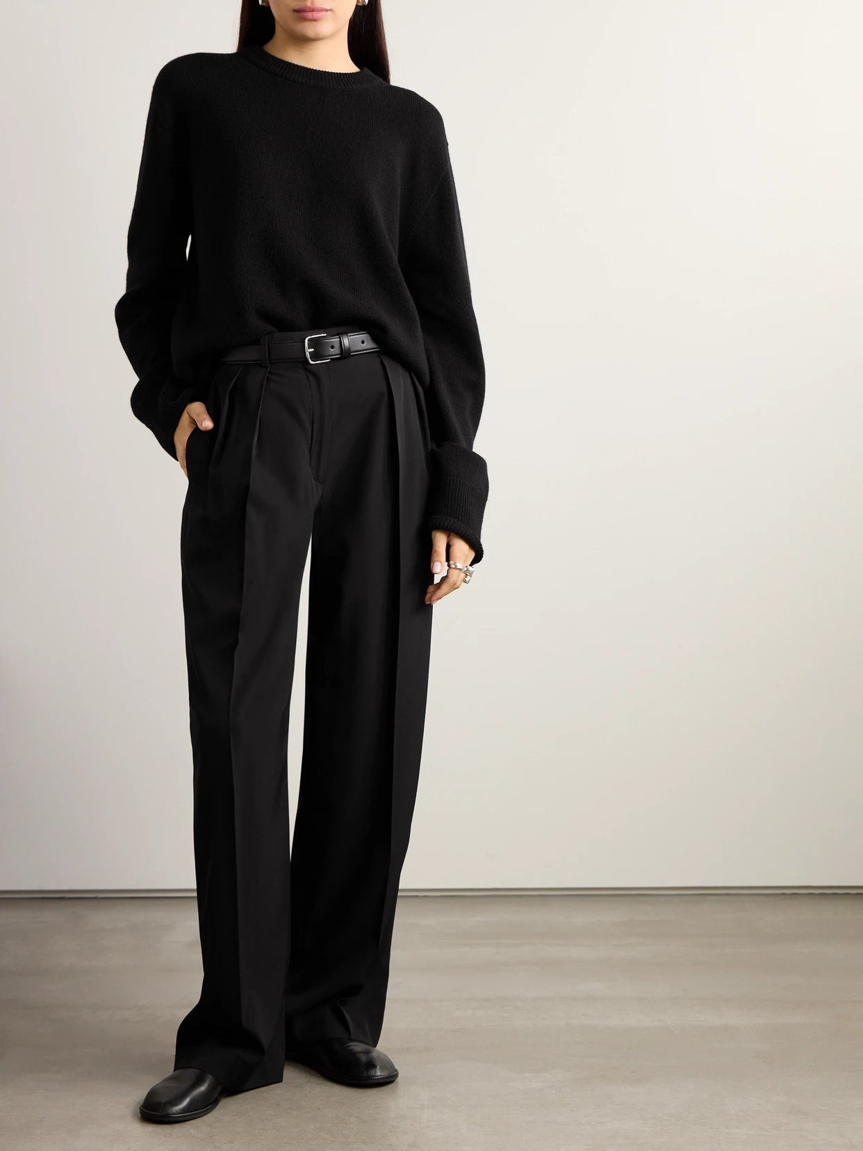 Image of a model wearing Pants. Product name - Essentials Igor Crepe Straight-leg Pants in Black colour by brand - The Row