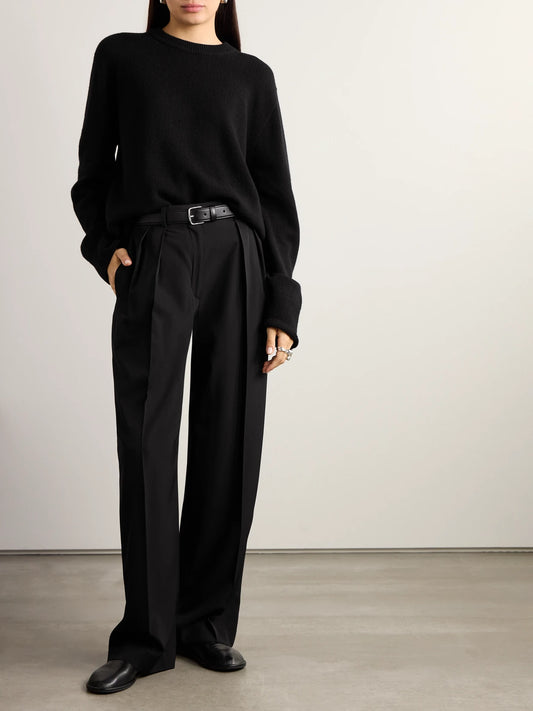 Image of a model wearing Pants. Product name - Essentials Igor Crepe Straight-leg Pants in Black colour by brand - The Row