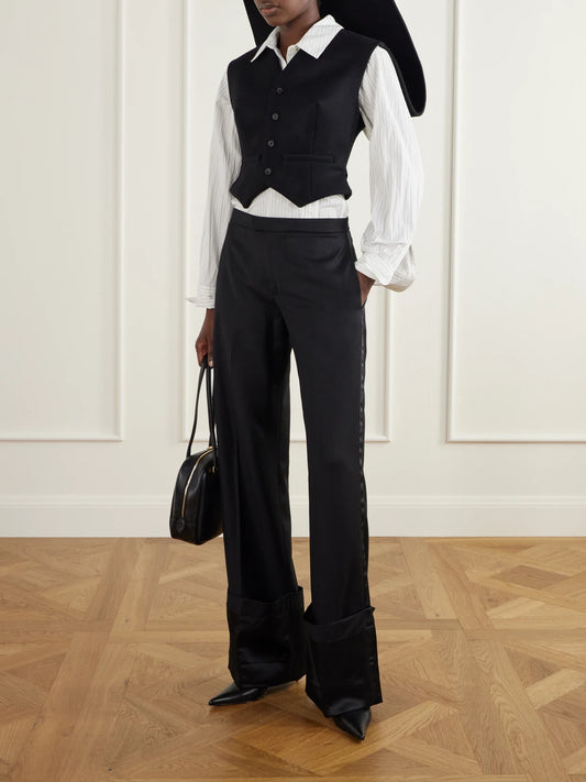Image of a model wearing Pants. Product name - Wool-twll Wide-leg Pants in Black colour by brand - Jean Paul Gaultier