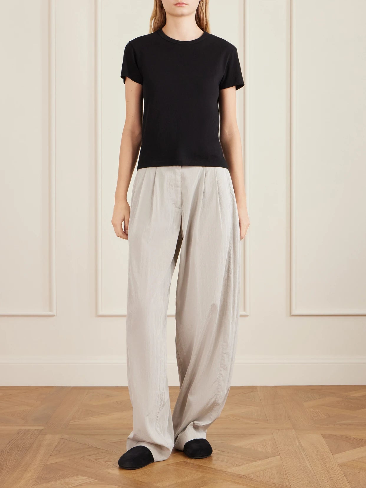 Image of a model wearing Tops. Product name - Jovita Cotton, Cashmere And Silk-blend Jersey T-shirt in Black colour by brand - The Row