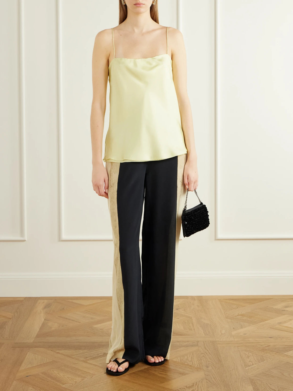 Image of a model wearing Pants. Product name - Sona Silk Crepe De Chine Wide-leg Pants in Cream colour by brand - SIR.