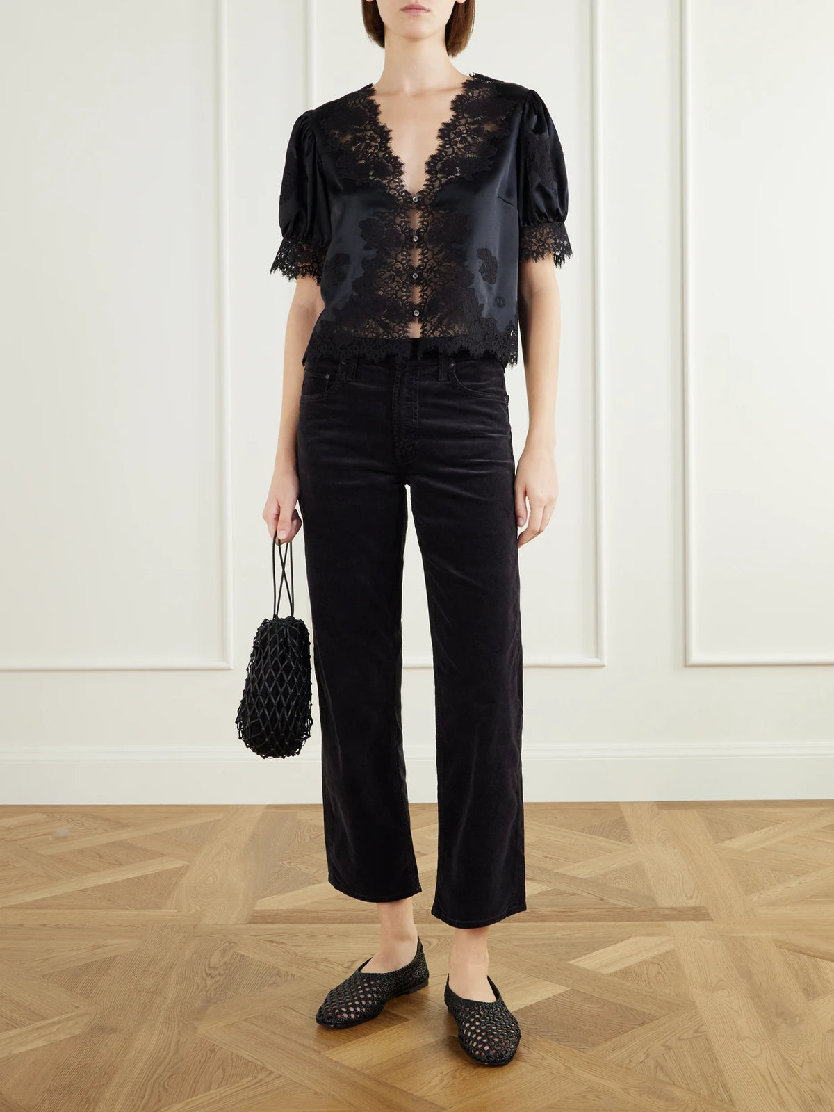 Image of a model wearing Tops. Product name - Idella Lace-trimmed Silk-satin Blouse in Black colour by brand - DÔEN