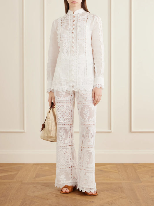 Image of a model wearing Pants. Product name - Aster Embroidered Mesh Flared Pants in Ivory colour by brand - Zimmermann