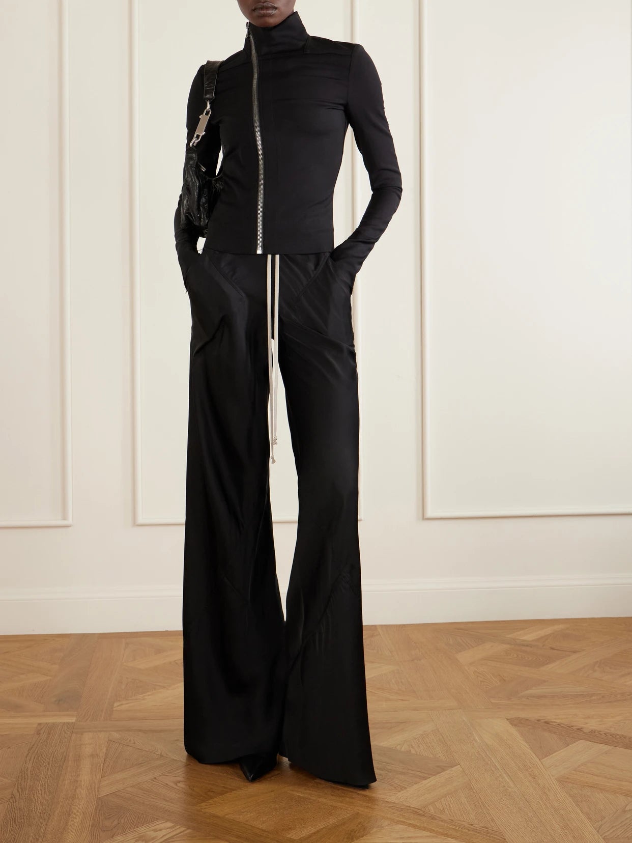 Image of a model wearing Pants. Product name - Charmeuse Wide-leg Drawstring Pants in Black colour by brand - Rick Owens