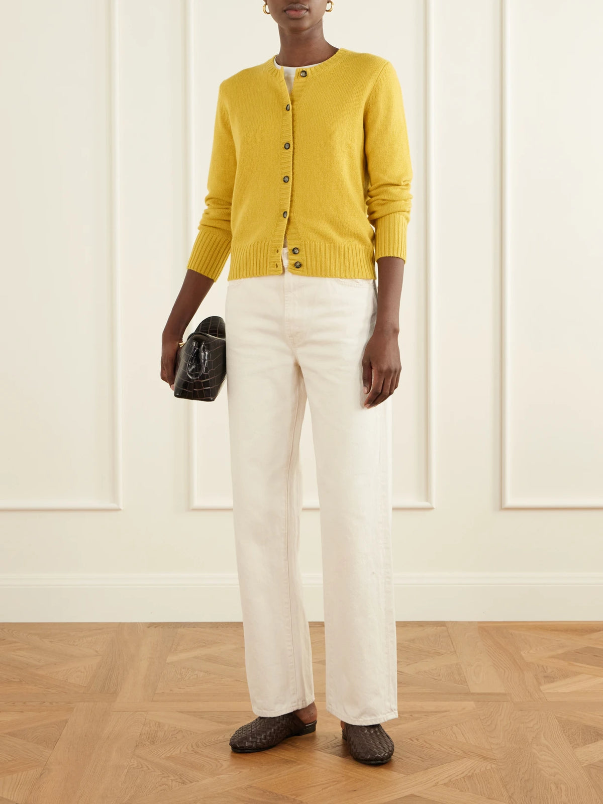 Image of a model wearing Outerwear. Product name - Ribbed Cashmere Cardigan in Mustard colour by brand - Allude