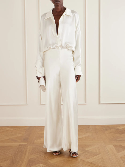 Image of a model wearing Pants. Product name - Satin High-rise Wide-leg Pants in White colour by brand - Norma Kamali