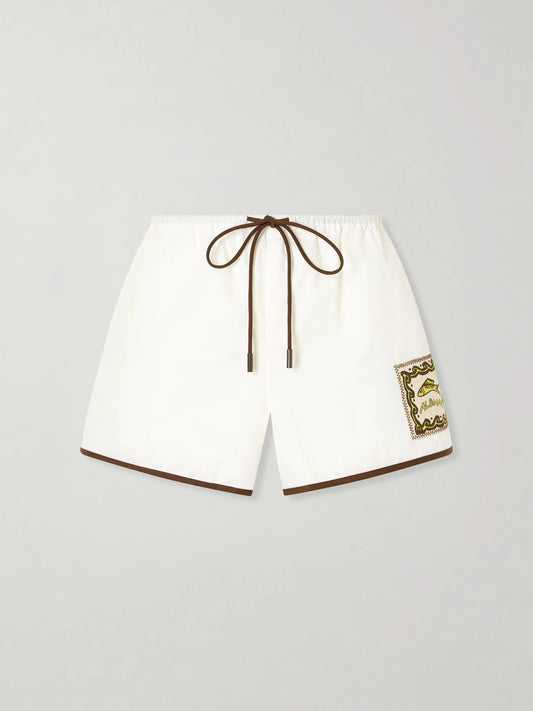 Image of a model wearing Shorts. Product name - Scuba Embroidered Cotton-poplin Shorts in Ivory colour by brand - ALÉMAIS