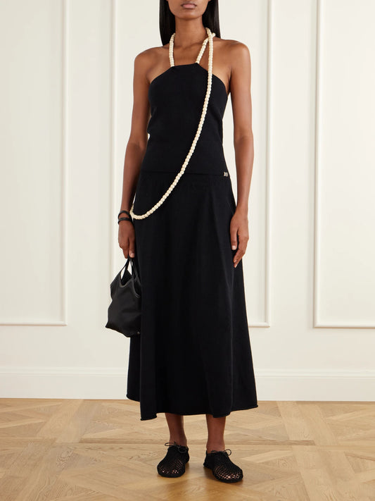 Image of a model wearing Skirts. Product name - Ease Knit Cashmere-blend Midi Skirt in Black colour by brand - Extreme Cashmere