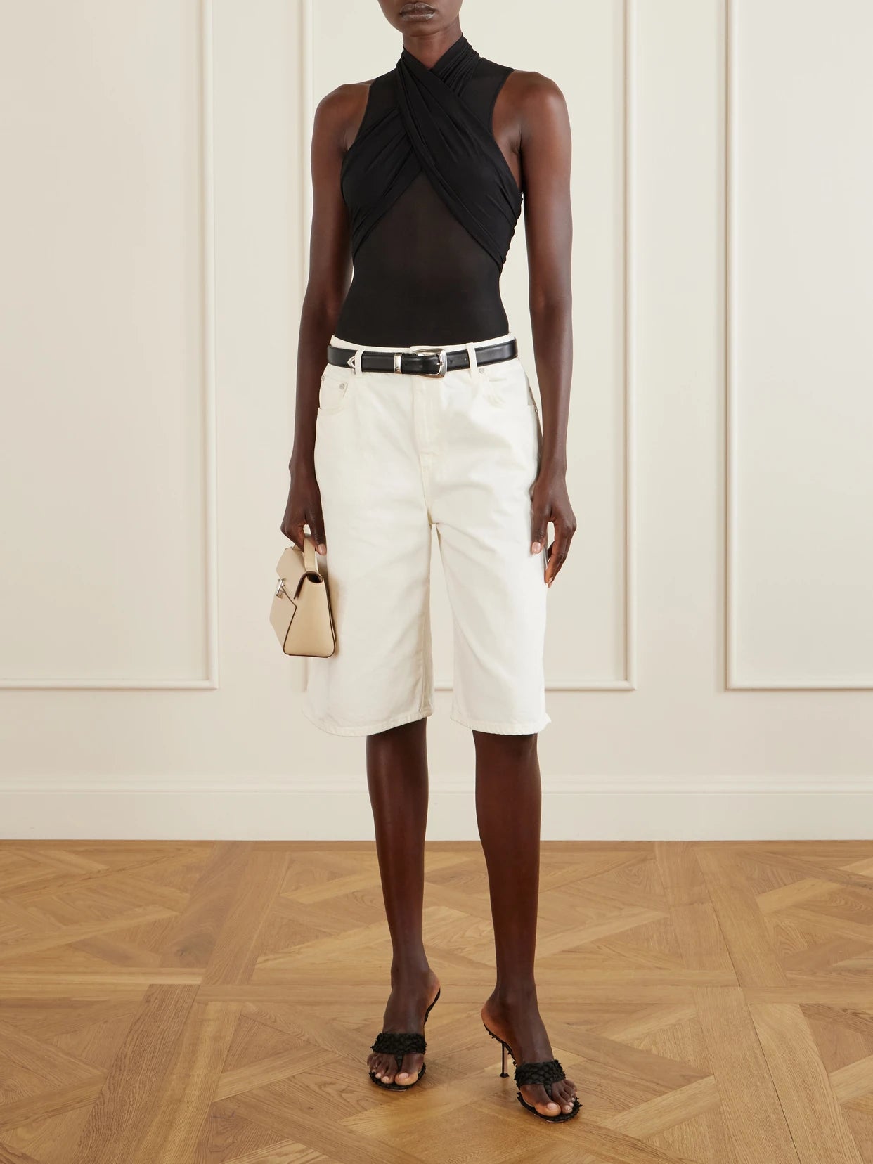 Image of a model wearing Tops. Product name - Mesh Bodysuit in Black colour by brand - WARDROBE. NYC