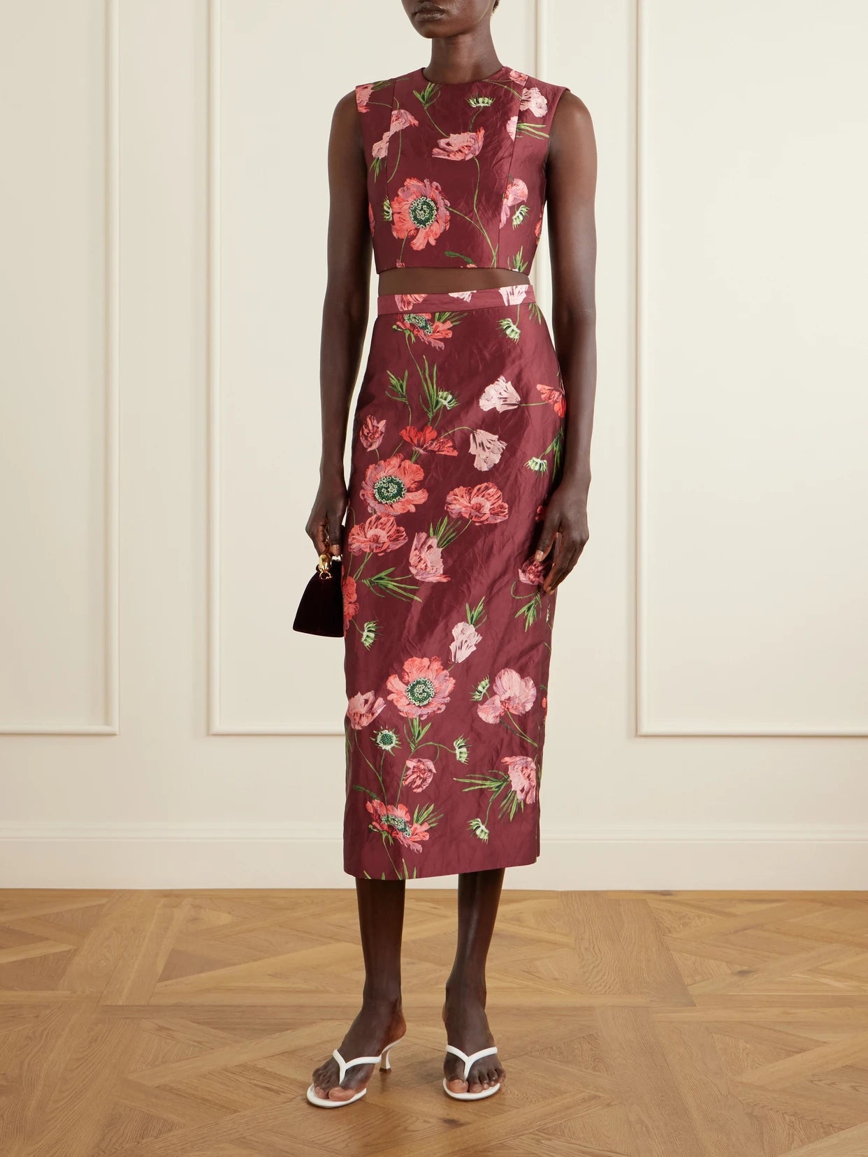 Image of a model wearing Tops. Product name - Floral-print Crinkled Satin Cropped Top in Burgundy colour by brand - Erdem